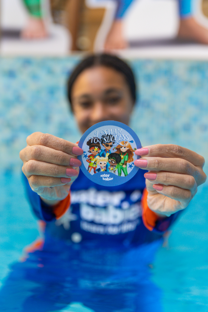 alice dearing with a water babies badge